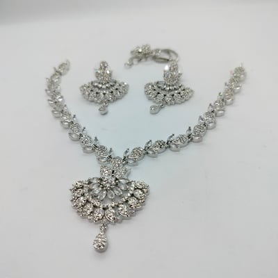 silver-toned necklace set matching earring sets