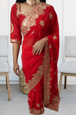 woman wearing a red embroidered saree, a traditional 